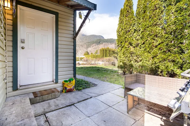 Doorway to property with a mountain view and a patio