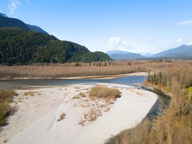 Property view of water featuring a wooded view and a mountain view