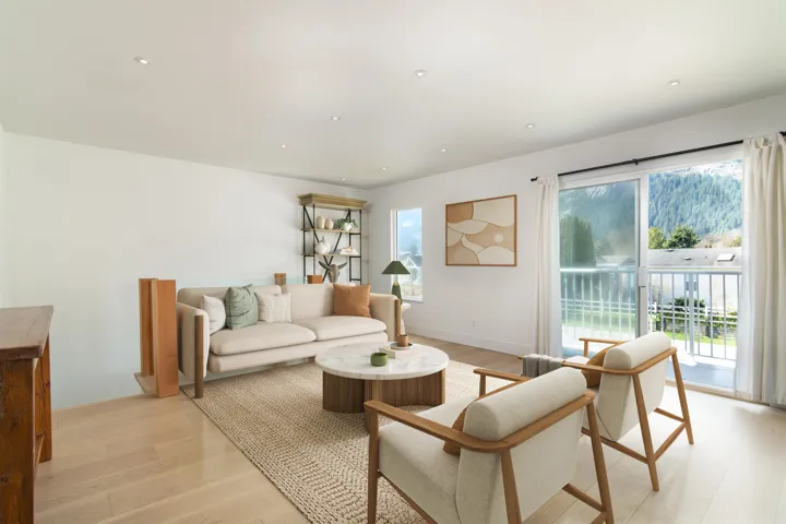 Living room featuring light wood finished floors, baseboards, and recessed lighting