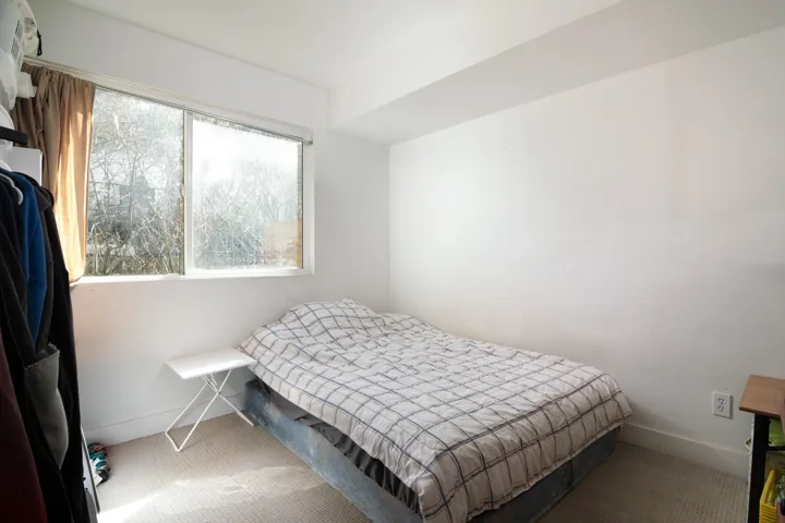Bedroom featuring baseboards and carpet