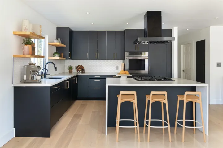 Kitchen with stainless steel oven, open shelves, a kitchen island, a sink, and island range hood