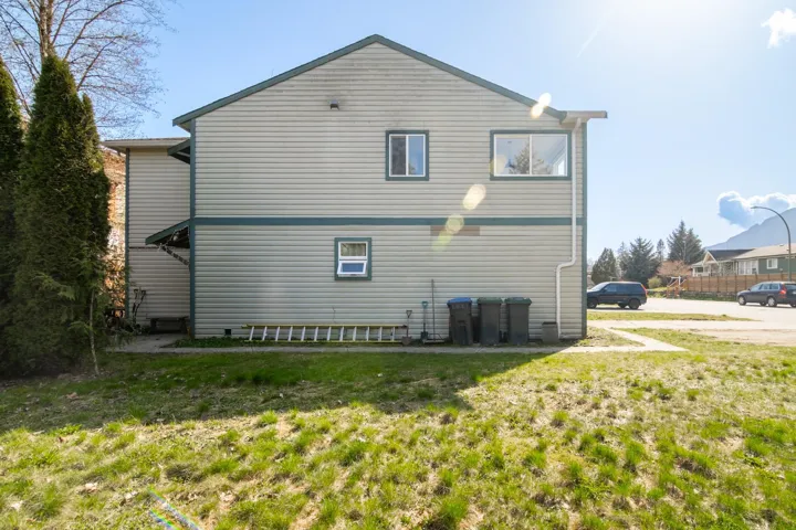 Rear view of property with a lawn