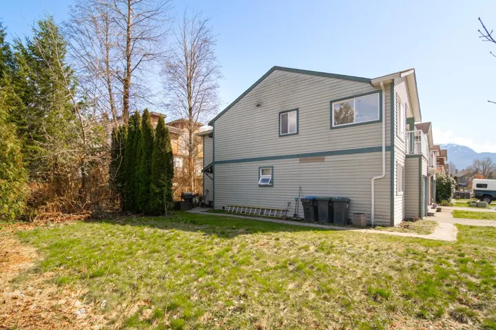 Back of house featuring a lawn