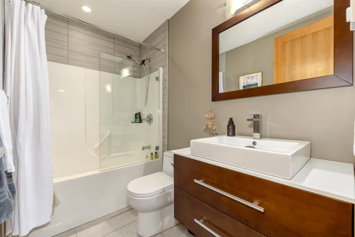 Bathroom with shower / tub combo and vanity