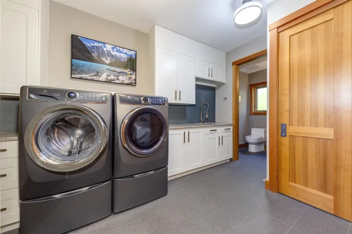 Laundry area featuring washing machine and clothes dryer and cabinet space