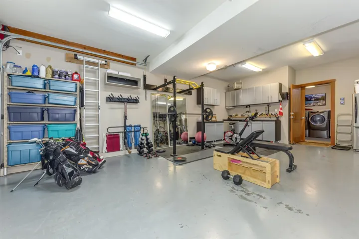 Garage with washer / clothes dryer and freestanding refrigerator