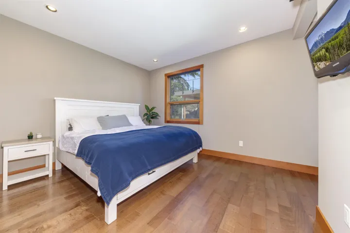 Bedroom with wood finished floors and recessed lighting