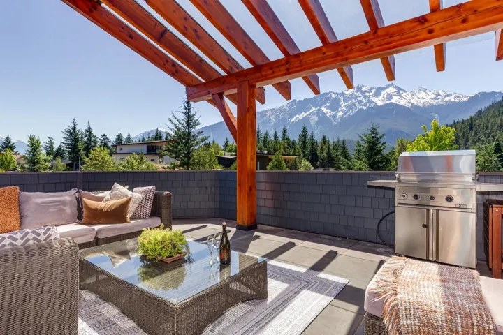 View of patio / terrace featuring a mountain view, an outdoor hangout area, and an outdoor kitchen
