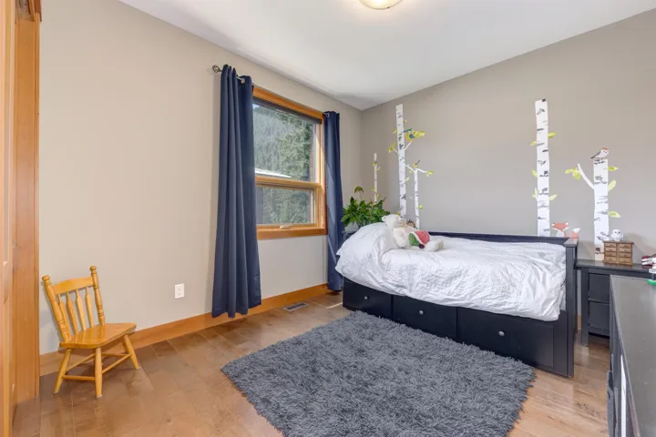 Bedroom with light wood-style floors and baseboards