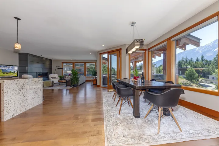 Dining space featuring a mountain view, light wood-type flooring, recessed lighting, and a fireplace