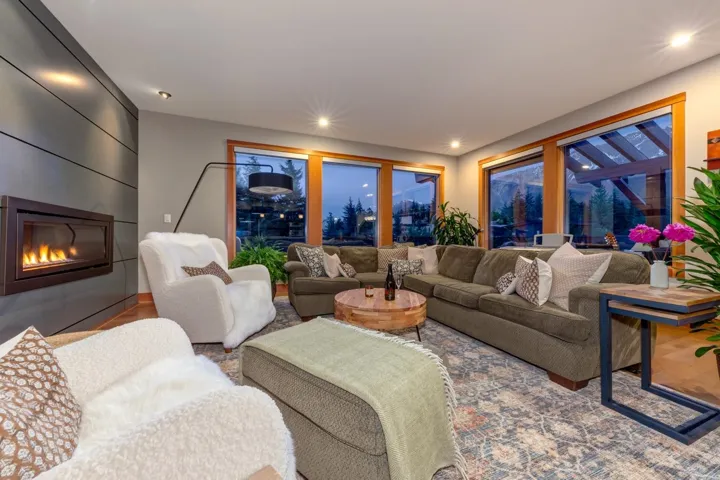 Living room featuring a large fireplace, recessed lighting, and wood finished floors