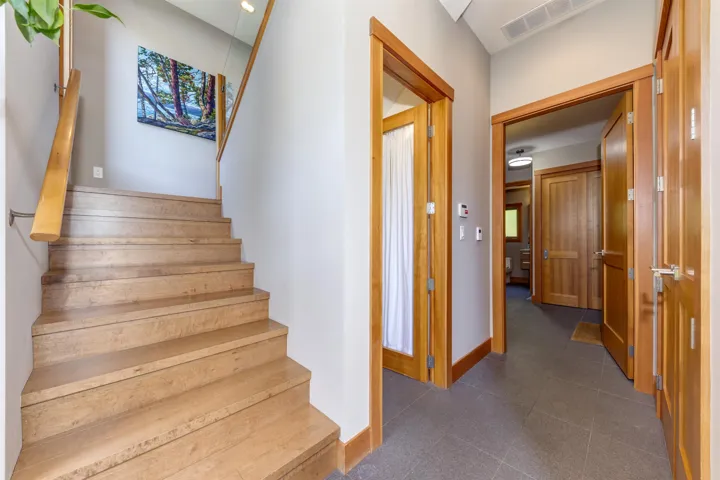 Stairway with baseboards and tile patterned floors