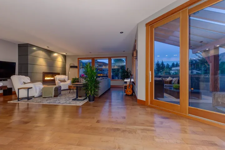 Living area with wood finished floors and a large fireplace