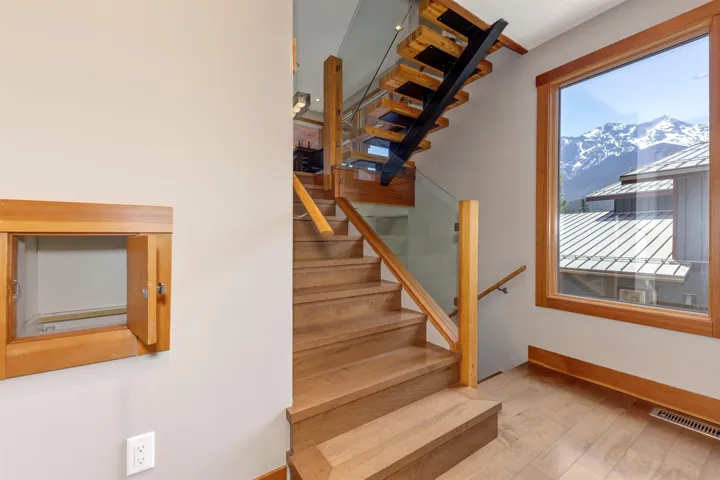 Stairway featuring wood finished floors and a mountain view