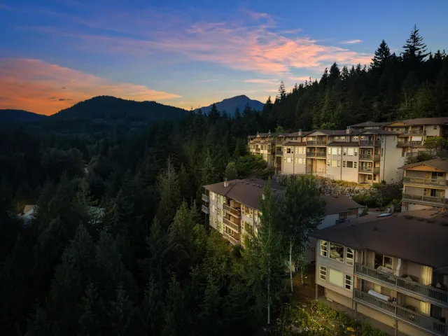 Terraced multi-story buildings featuring balconies and expansive windows
