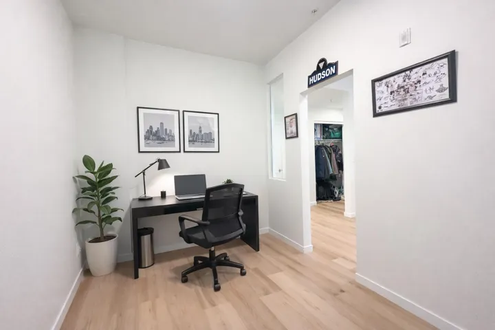 Office with light wood-style flooring and baseboards