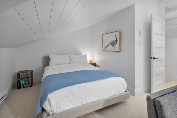 Bedroom with carpet floors, baseboards, and baseboard heating