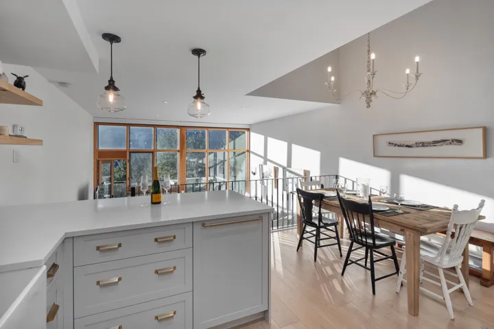 Kitchen with light countertops, a peninsula, open shelves, and light wood finished floors