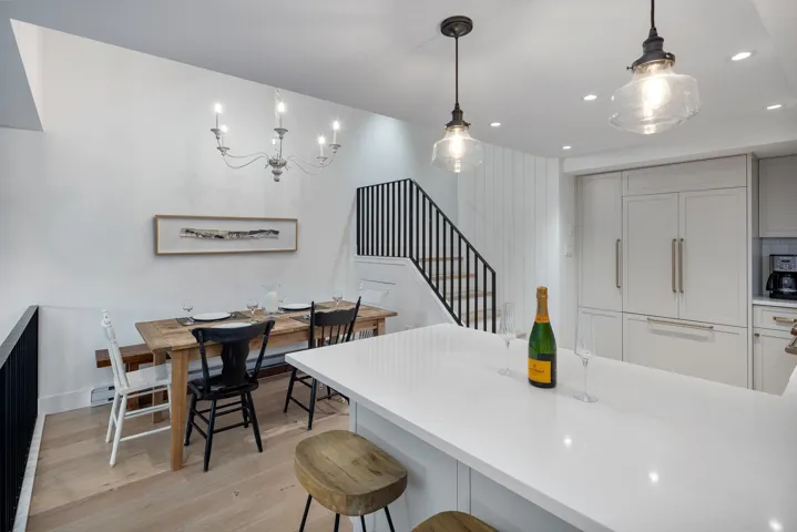 Kitchen featuring light countertops, recessed lighting, a kitchen breakfast bar, and light wood-type flooring