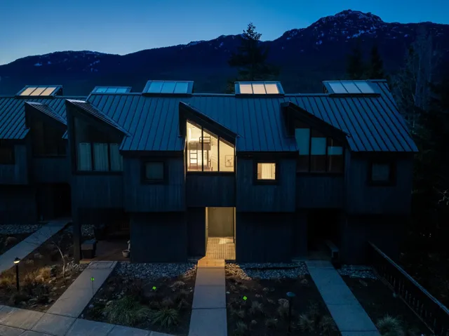 View of front of home with a standing seam roof, metal roof, and a mountain view