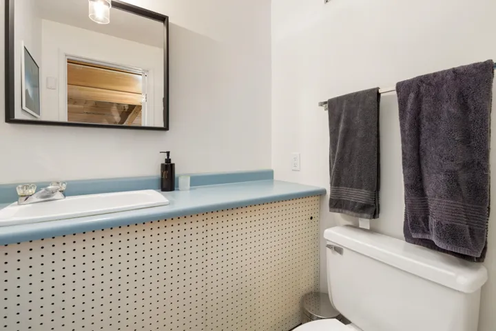Half bath featuring toilet and vanity