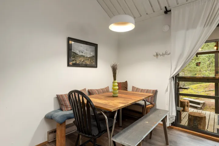 Dining space featuring wood finished floors and baseboard heating