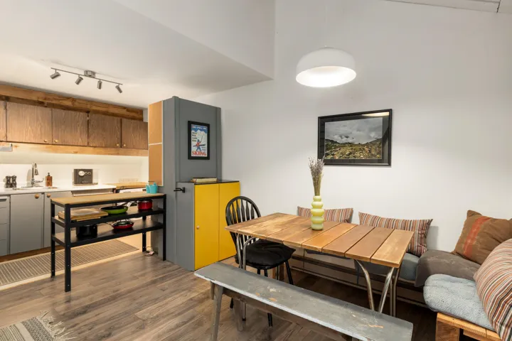 Living area with a wood stove, stairway, light wood-style flooring, and wood ceiling