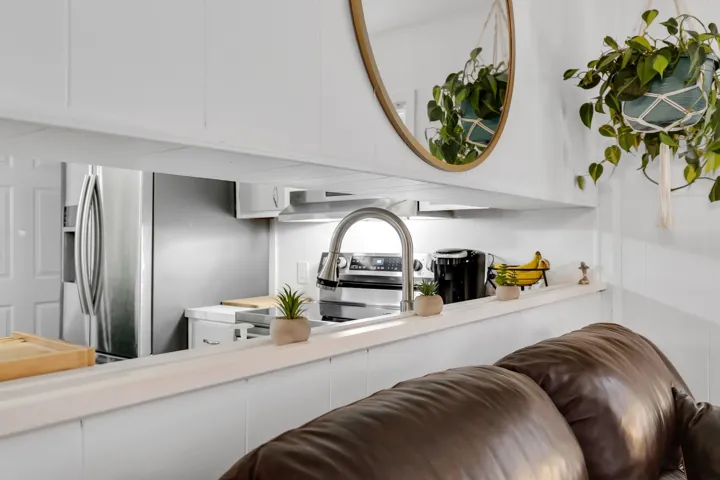 Kitchen featuring white cabinets, light countertops, and stainless steel appliances