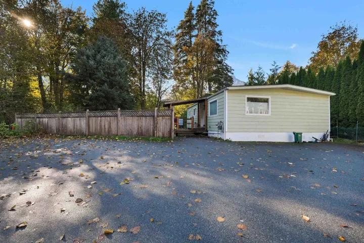 View of side of property featuring a wooden deck