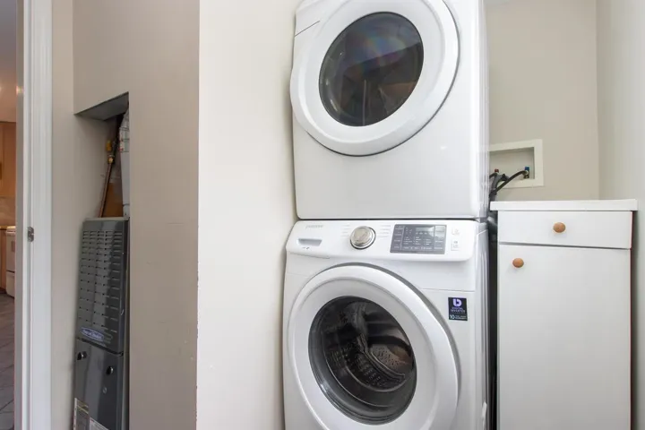 Laundry area featuring stacked washer and clothes dryer