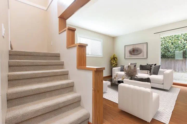 Living area featuring stairs and wood finished floors