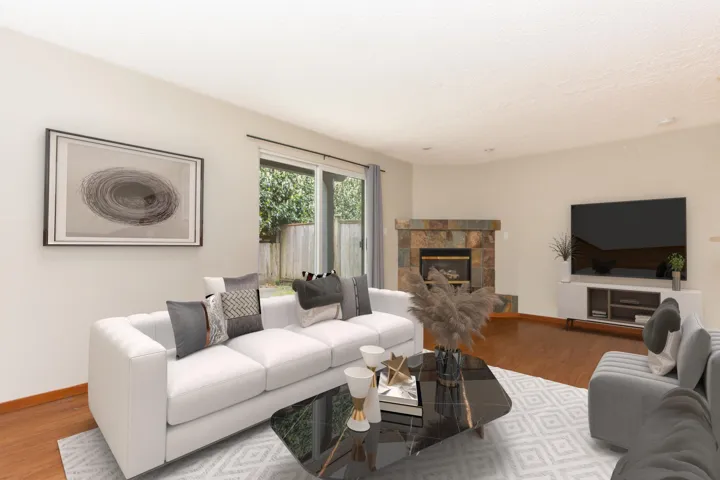 Living room with wood finished floors, a fireplace, and a textured ceiling