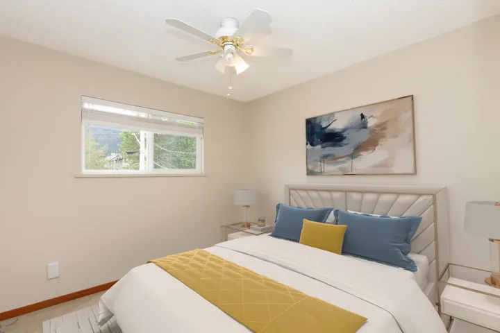 Bedroom featuring a ceiling fan, a textured ceiling, and carpet floors