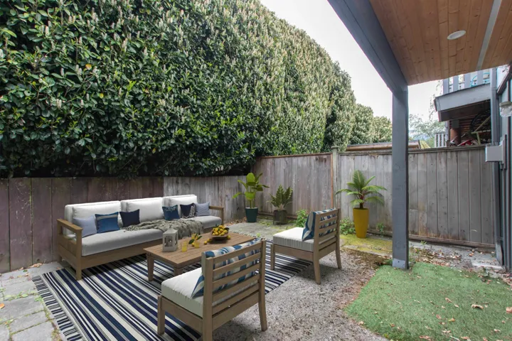 Fenced backyard with an outdoor hangout area and a patio area