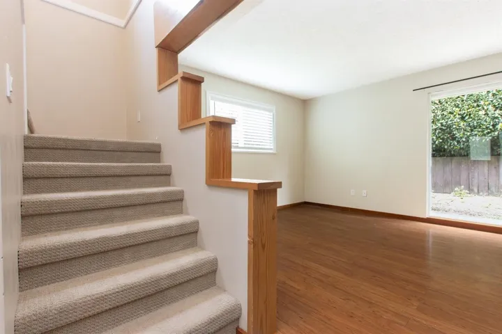 Stairway featuring wood finished floors and baseboards
