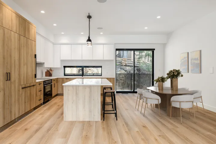 Kitchen with modern cabinets, a center island, a breakfast bar, and recessed lighting