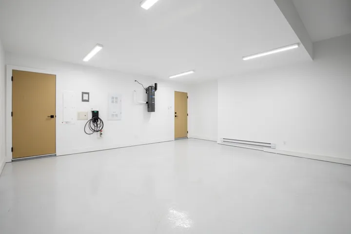 Garage featuring a baseboard radiator and a central vacuum unit