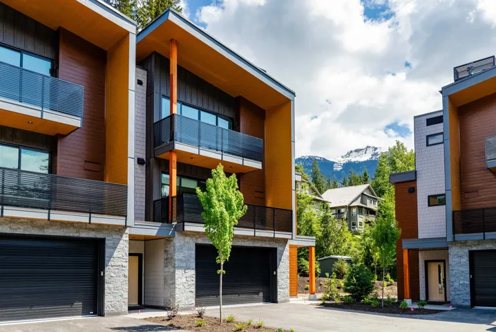 View of building exterior featuring a mountain view and an attached garage