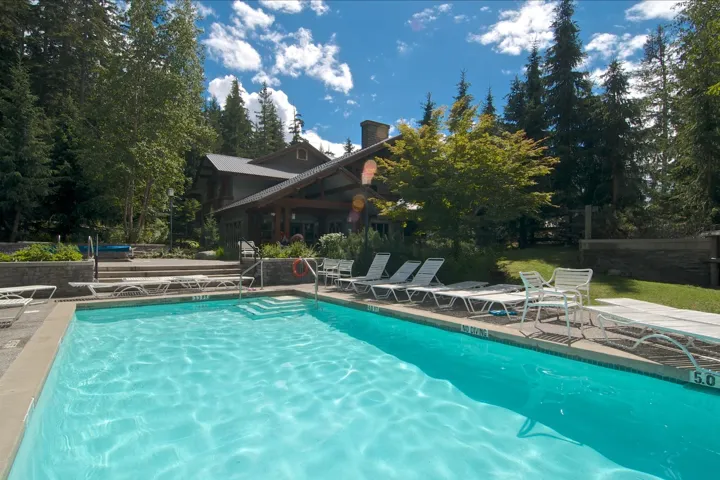 Community pool with a patio