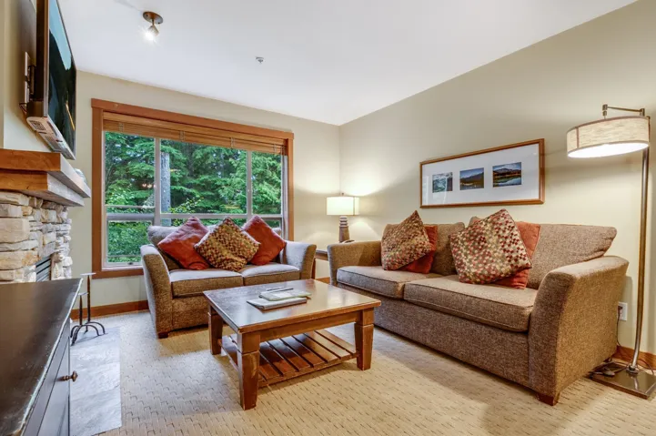 Living room featuring baseboards and a fireplace