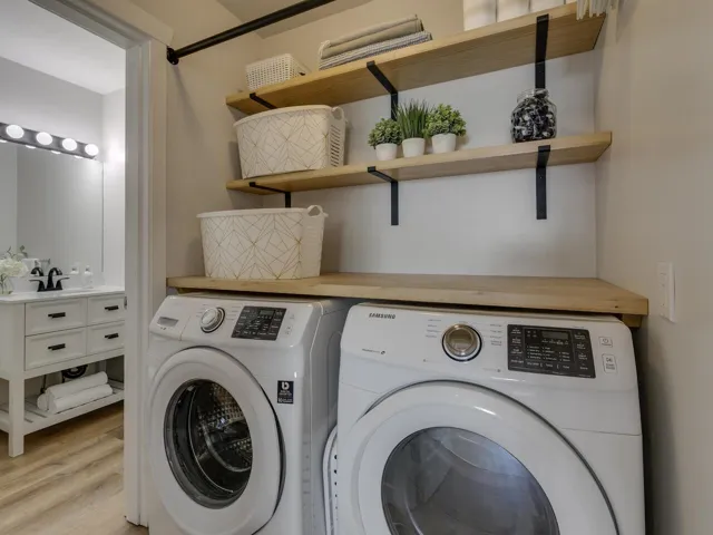 Laundry room featuring light wood finished floors, laundry area, and separate washer and dryer