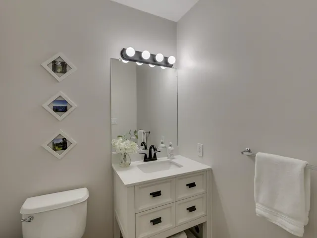 Half bathroom featuring toilet and vanity