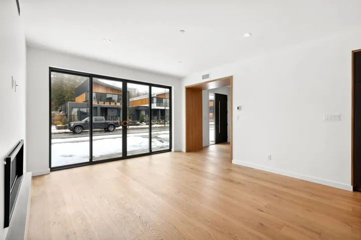 Unfurnished room featuring visible vents, light wood-style flooring, and baseboards