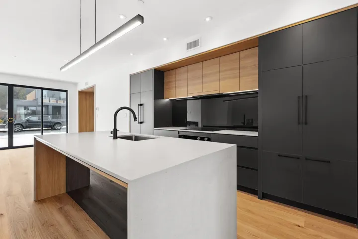Kitchen featuring light wood-type flooring, modern cabinets, and a sink