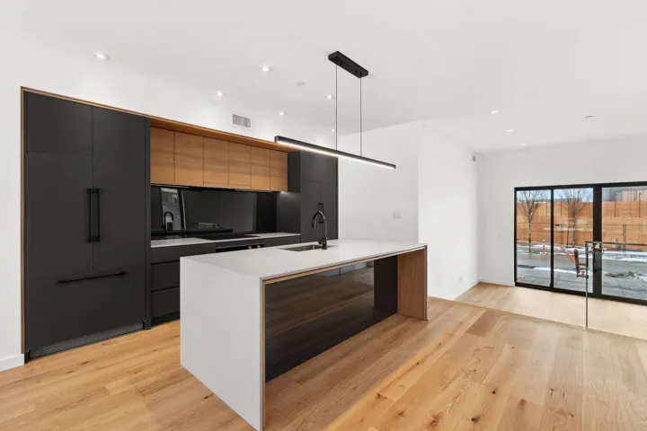 Kitchen featuring light wood-style flooring, a sink, visible vents, light countertops, and modern cabinets