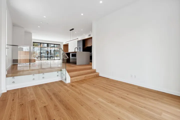 Empty room with light wood-style floors, recessed lighting, stairway, and baseboards