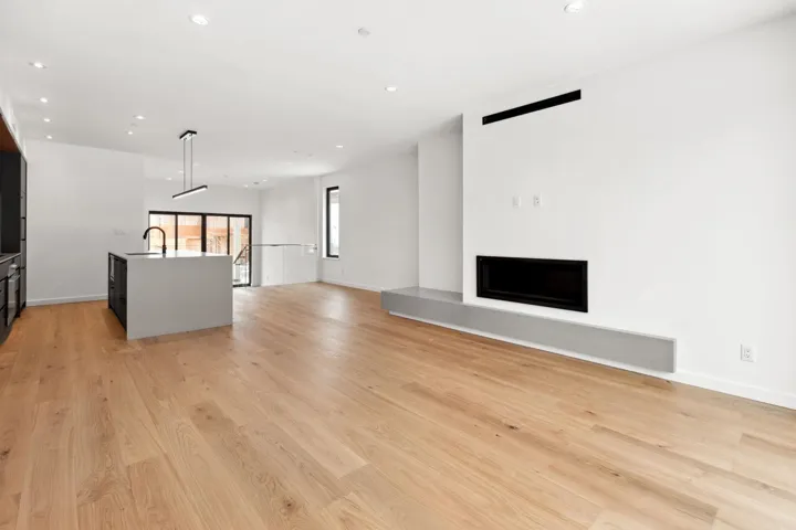 Unfurnished living room with recessed lighting, baseboards, a sink, and light wood finished floors