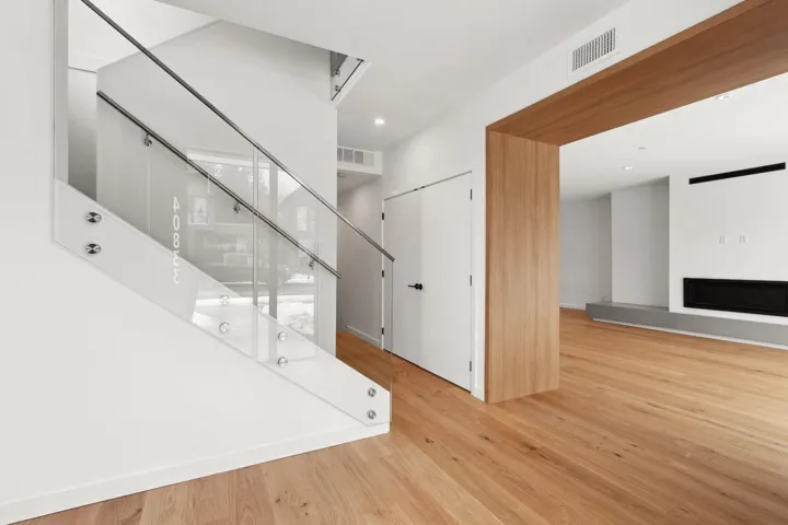 Interior space featuring a fireplace, visible vents, wood finished floors, and recessed lighting