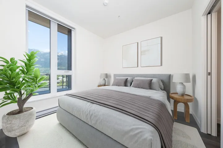 Bedroom with multiple windows, wood finished floors, and a baseboard heating unit