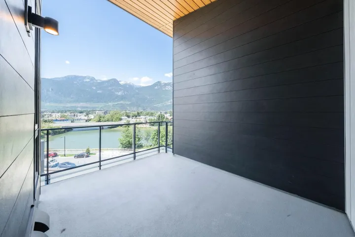Balcony featuring a water and mountain view